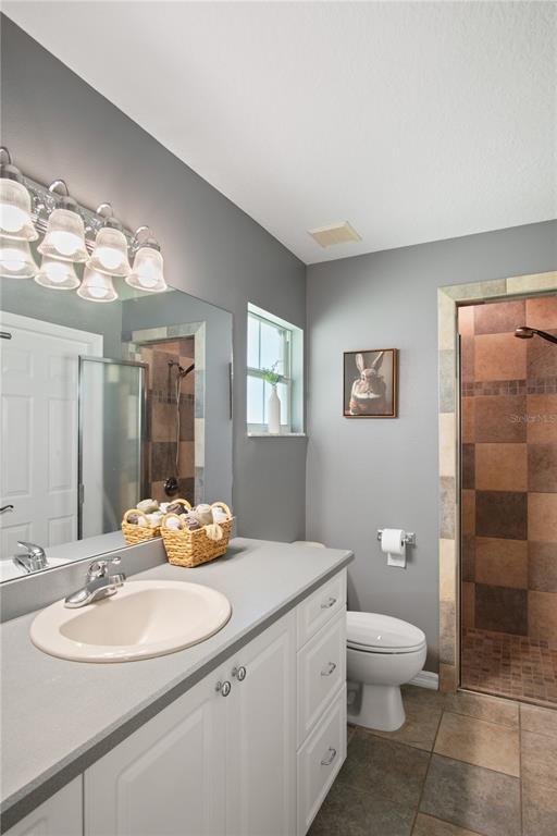 9045 Lake Hatchineha Road Kissimmee, FL 34759 - Photo 37 of 47 a bathroom with a sink a toilet and shower