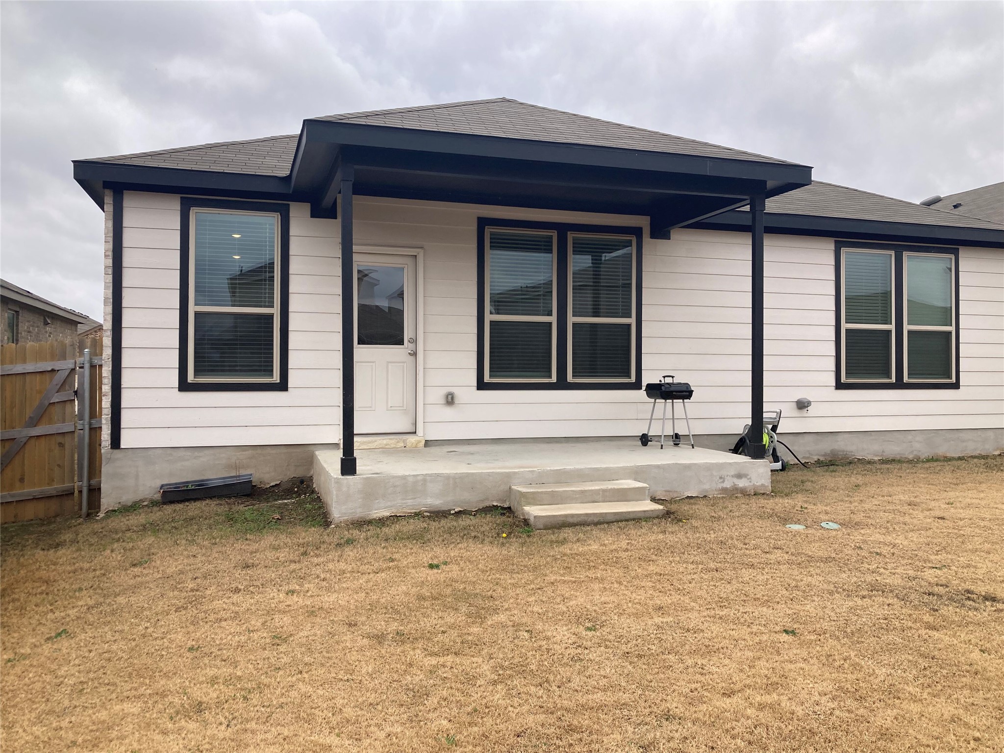 137 Onna Street Taylor, TX 76574 - Photo 12 of 13 Back of home featuring a porch