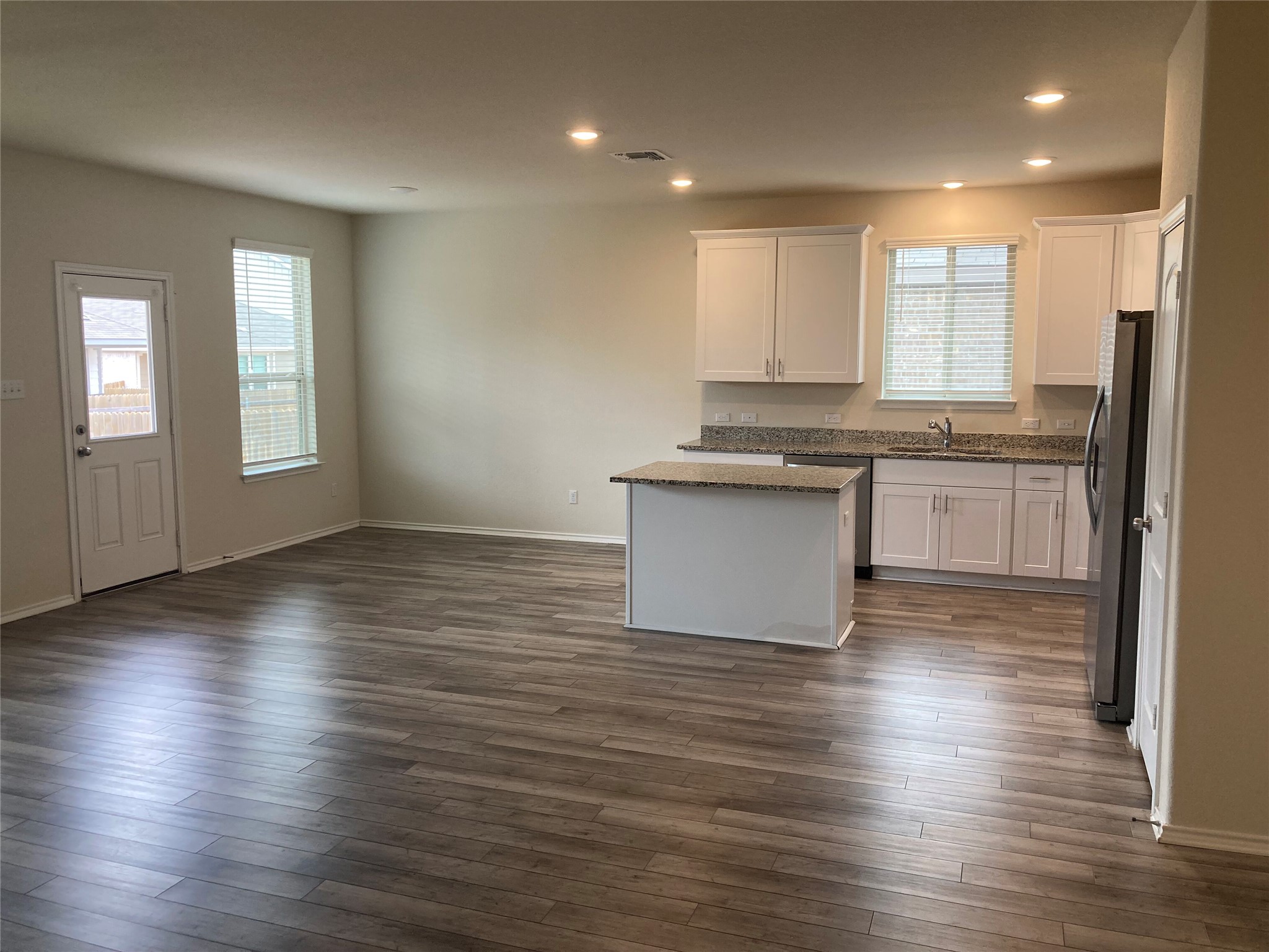 137 Onna Street Taylor, TX 76574 - Photo 2 of 13 Kitchen, Dining Room, & Family Room
