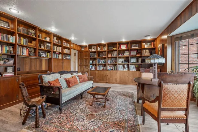 a living room with furniture and a book shelf