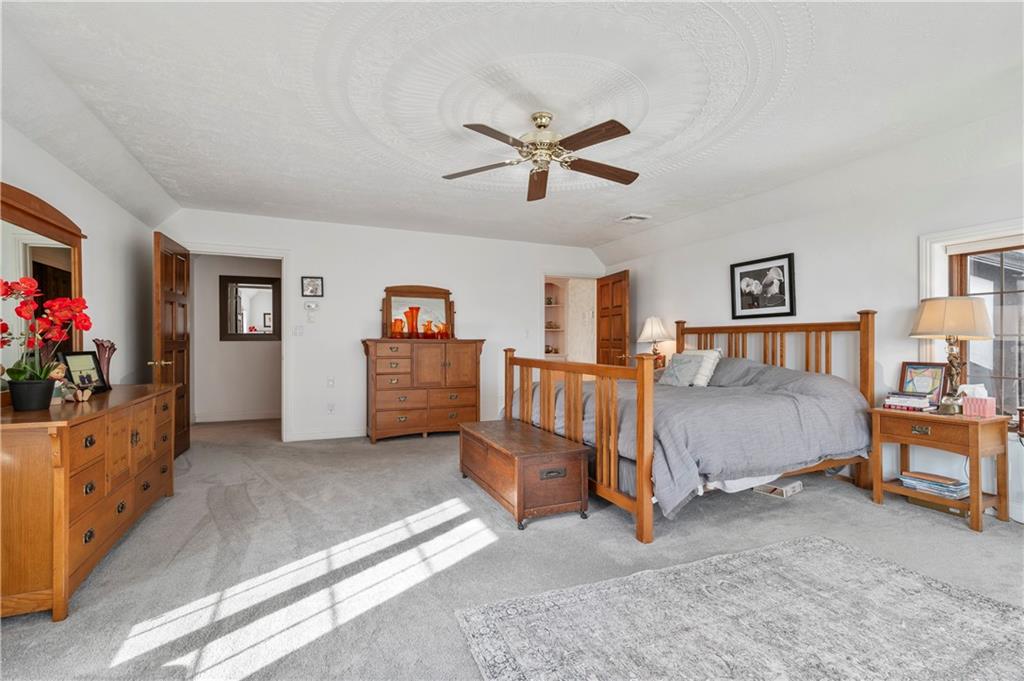 620 North Franklin Avenue Somerset, PA 15501 - Photo 20 of 37 a spacious bedroom with a bed and a chandelier