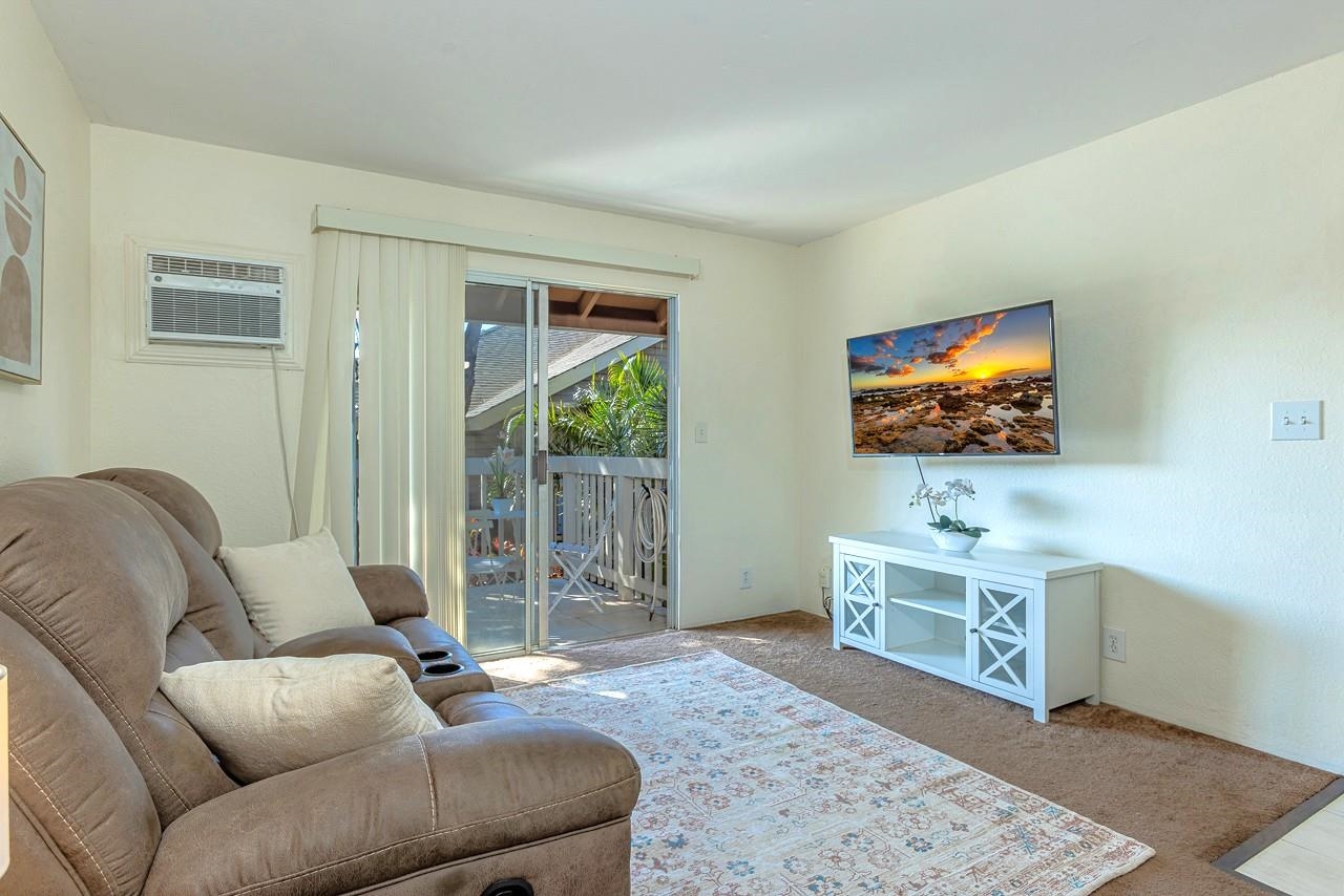 140 Uwapo Road, Unit 55205 Kihei, HI 96753 - Photo 11 of 31 a living room with furniture and a flat screen tv