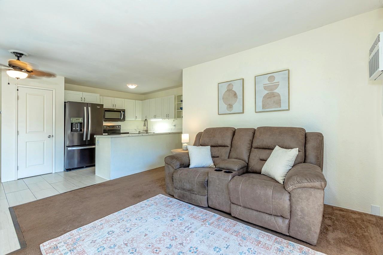 140 Uwapo Road, Unit 55205 Kihei, HI 96753 - Photo 8 of 31 a living room with furniture and kitchen view