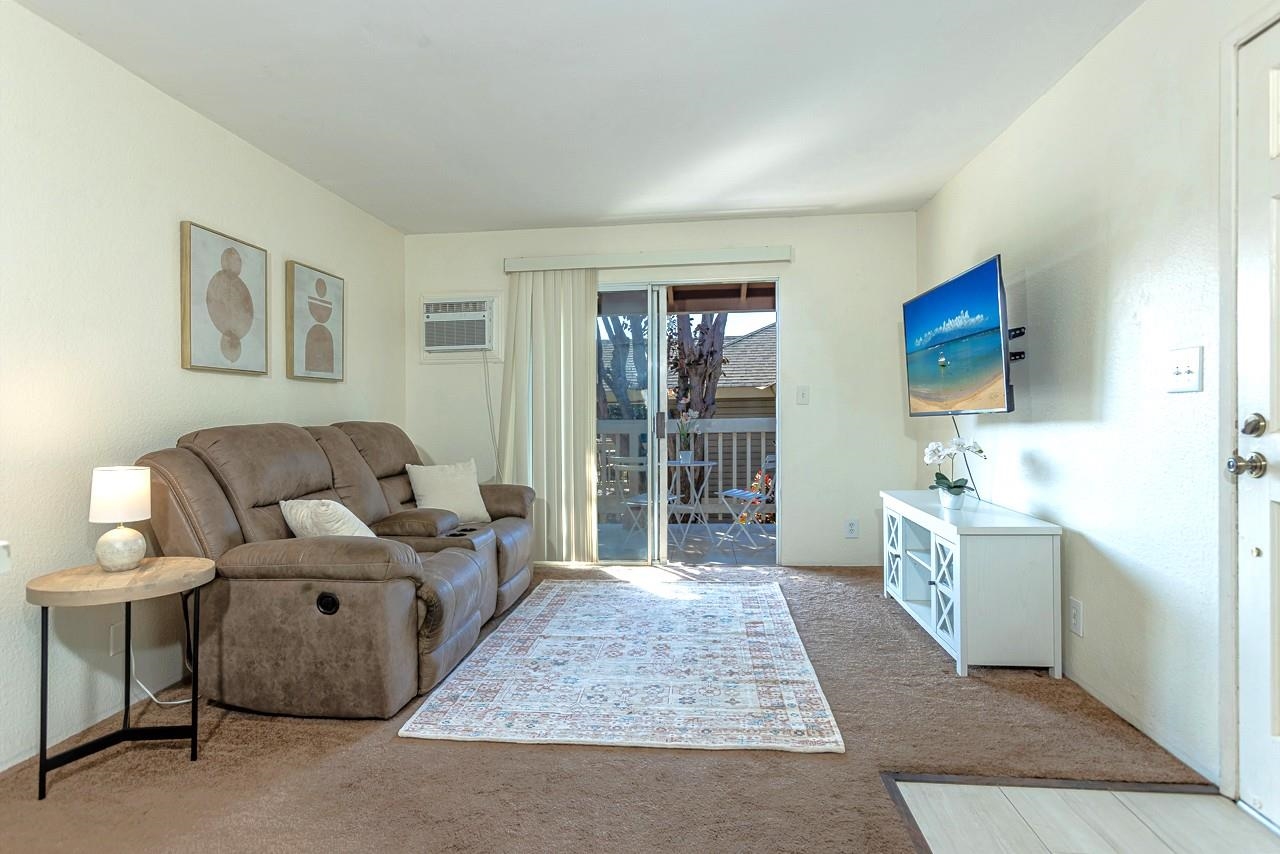 140 Uwapo Road, Unit 55205 Kihei, HI 96753 - Photo 9 of 31 a living room with furniture and a window