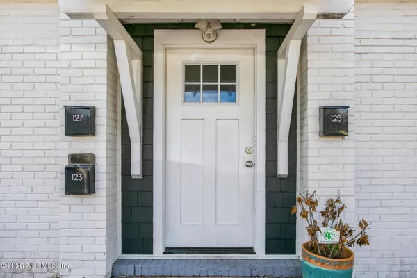a view of entryway with wooden floor and stairs