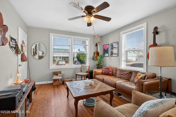 a living room with furniture and a wooden floor