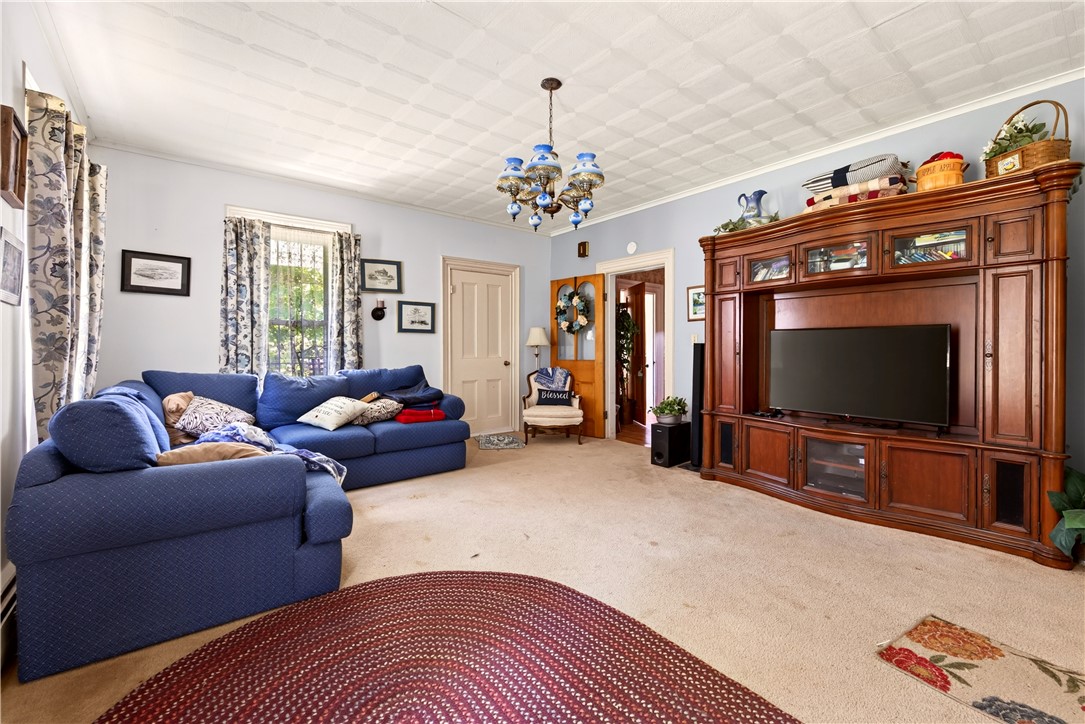 7780 Cold Springs Road Bath, NY 14810 - Photo 12 of 50 A spacious living room features classic textured ceilings and a built-in wooden entertainment center.