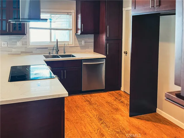 a kitchen with a sink a stove and a refrigerator