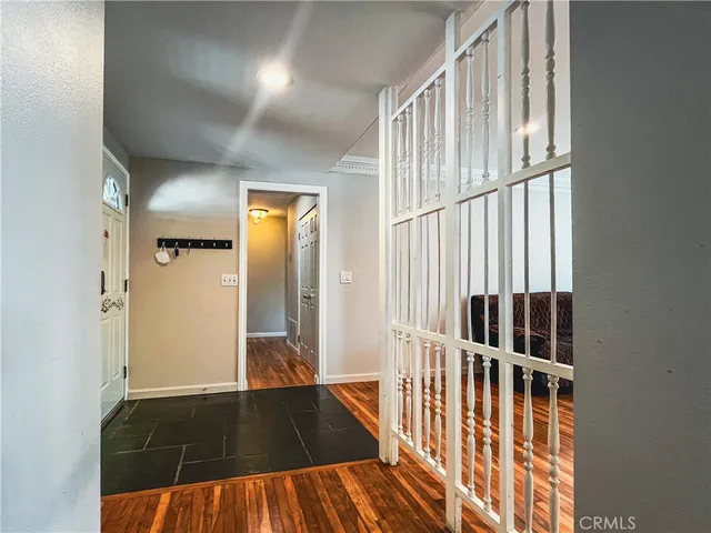 view of wooden floor in a hall with a window