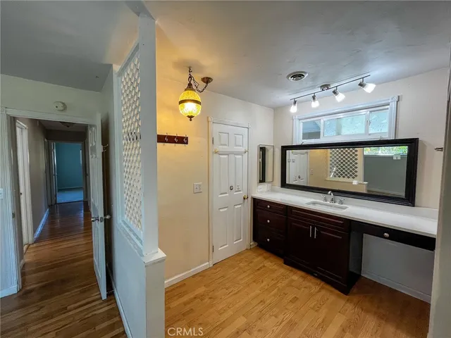 a spacious bathroom with a granite countertop sink and a mirror