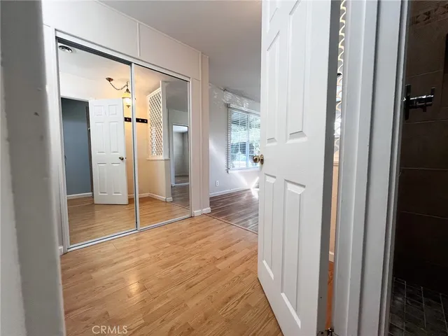 a view of a big room with closet and wooden floor