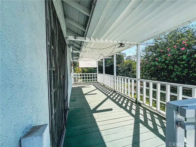a view of balcony with wooden floor and outdoor seating