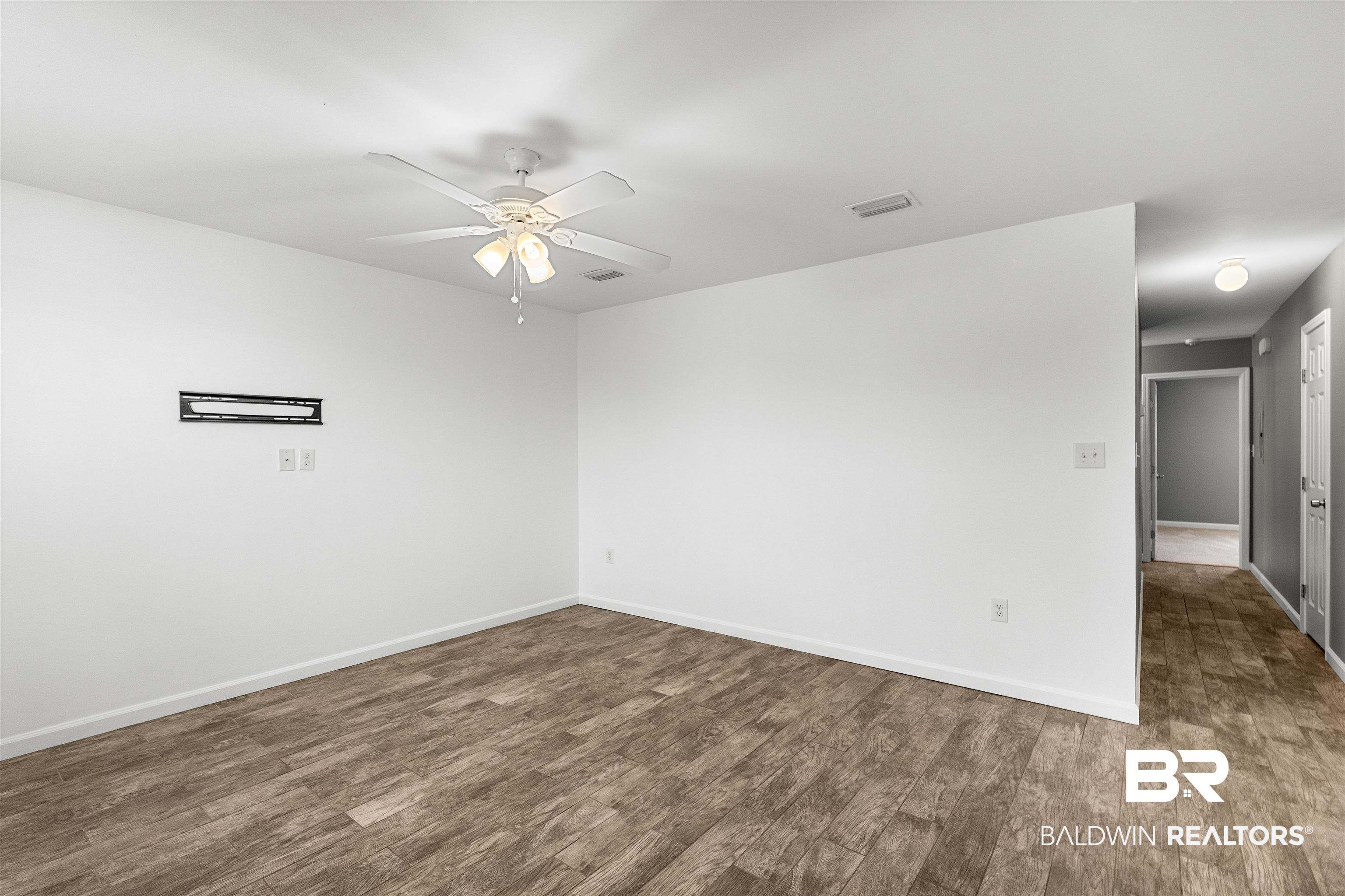 15131 Marem Drive Foley, AL 36535 - Photo 4 of 13 Spare room featuring ceiling fan and dark wood finished floors