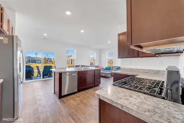a kitchen with a stove and a wooden floors