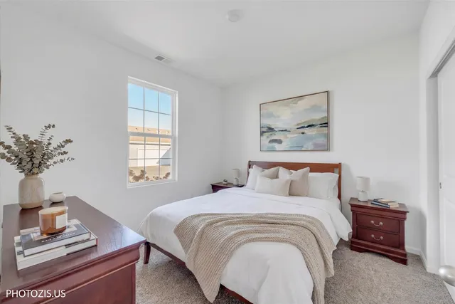 a bedroom with a bed and a potted plant