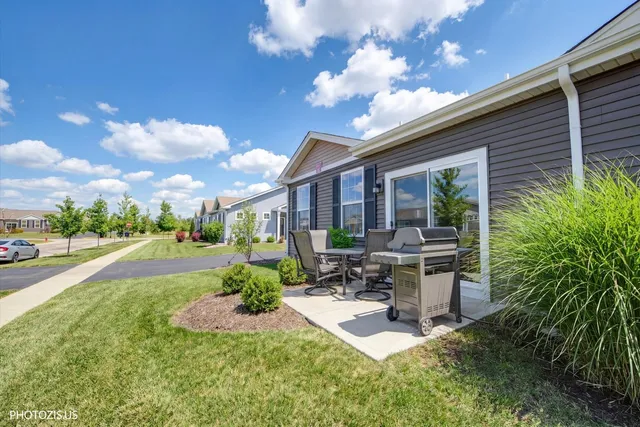 a view of a patio with table and chairs potted plants and a large tree