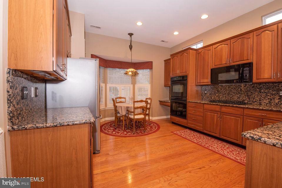 110 Wild Dunes Way Jackson, NJ 08527 - Photo 37 of 82 a kitchen with stainless steel appliances granite countertop a sink a stove and a refrigerator