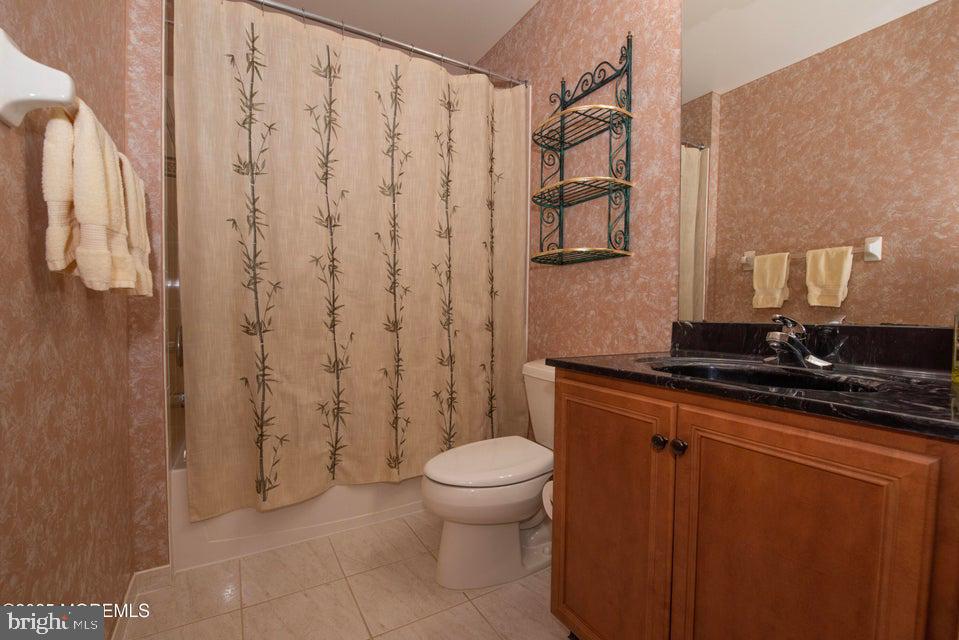 110 Wild Dunes Way Jackson, NJ 08527 - Photo 61 of 82 a bathroom with a granite countertop sink a toilet and a shower curtain