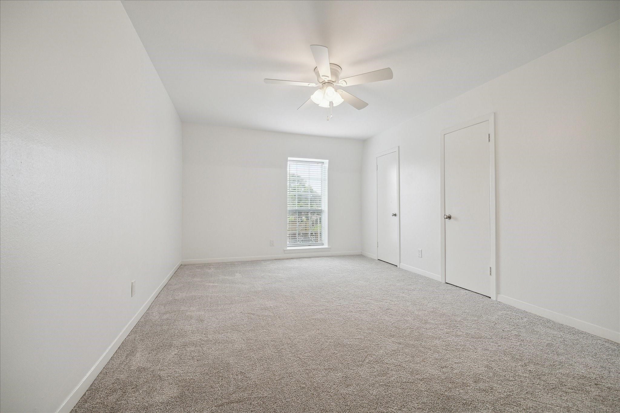 7821 Rue St Cyr Street, Unit 55 Houston, TX 77074 - Photo 10 of 16 Expansive primary bedroom with fresh carpet and abundant natural light.