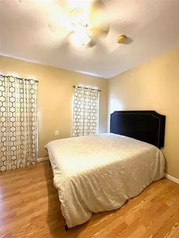 a large bed sitting in a bedroom next to a lamp