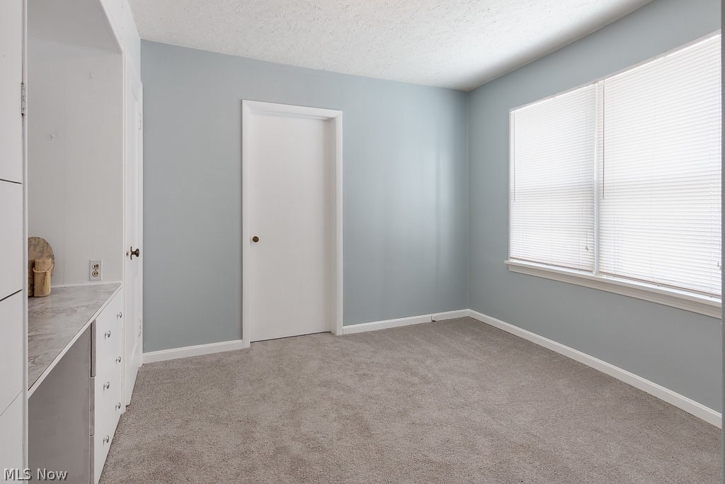 5121 Bridgewater Road Cleveland, OH 44124 - Photo 20 of 33 Second bedroom is cute and has great natural lighting. Freshly painted with new carpet. Also built ins that could serve as a desk or make up table.