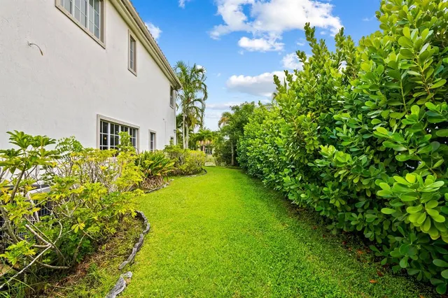 a yellow house with garden in front of it
