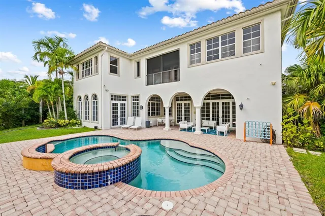 a view of a house with swimming pool and porch