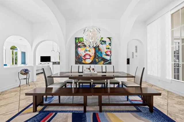 a view of a dining room with furniture one side and wooden floor