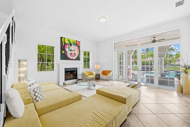 a living room with furniture large window and fireplace