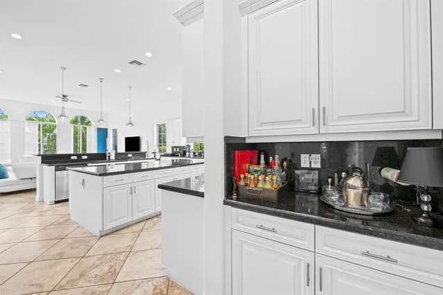 a kitchen with stainless steel appliances granite countertop a sink and cabinets