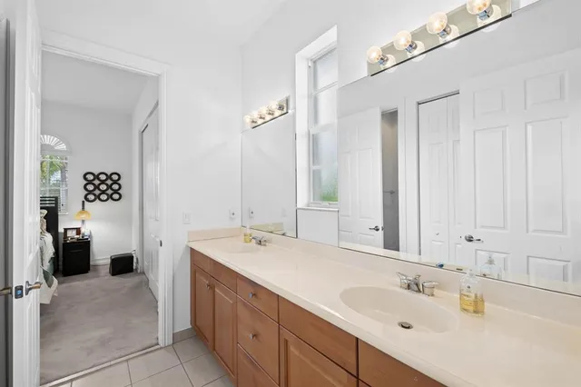 a spacious bathroom with a double vanity sink and a mirror