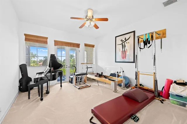 a living room with furniture gym equipment and a large window