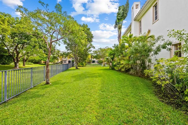 a view of a backyard with large trees