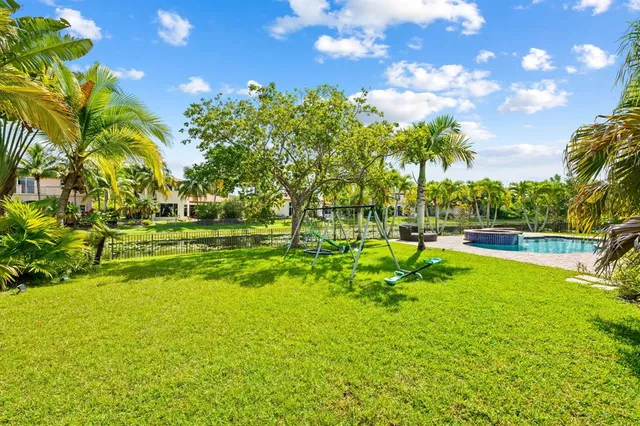 a view of yard with swimming pool and green space