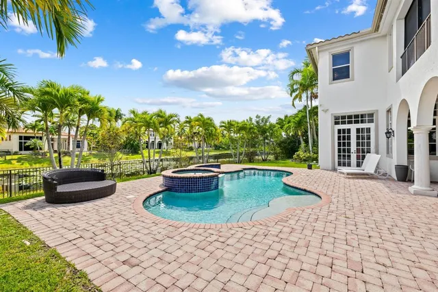 a view of swimming pool with outdoor seating and plants