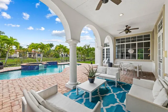 a view of a patio with couches chairs and potted plants