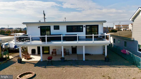 a view of roof deck with chairs a barbeque with wooden floor and fence