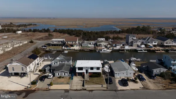 an aerial view of a house with wooden floor and lake view