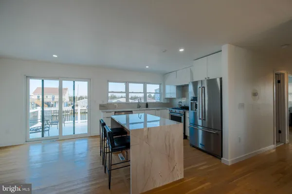a kitchen with a stove top oven and refrigerator