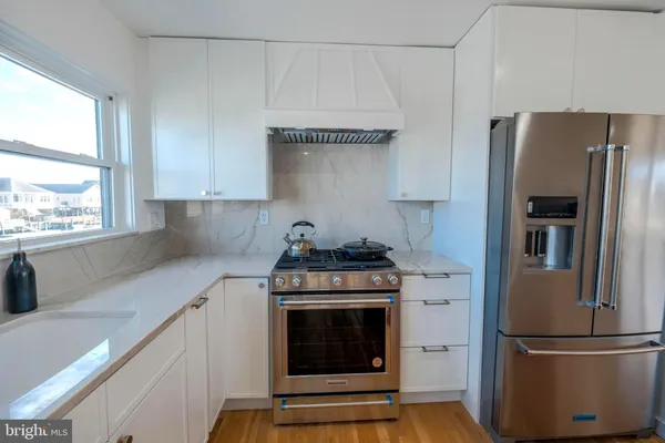 a kitchen with stainless steel appliances granite countertop a stove and a sink