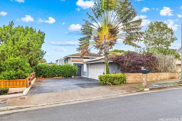 a front view of a house with a yard and a garage