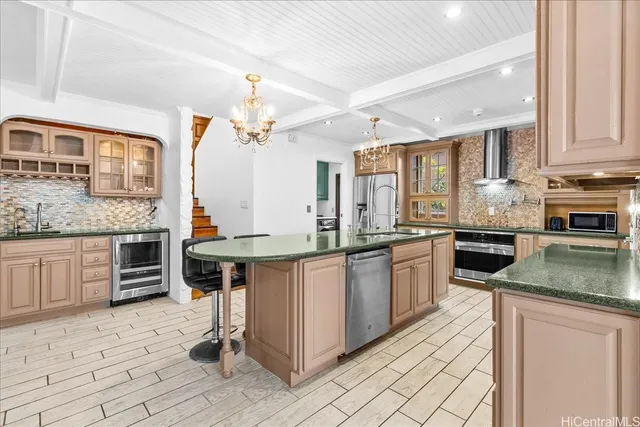 a kitchen with stainless steel appliances granite countertop a stove sink and cabinets