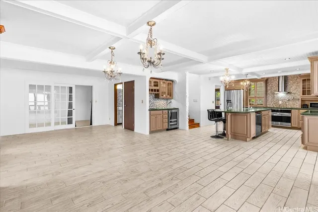 a view of a kitchen with refrigerator and cabinets