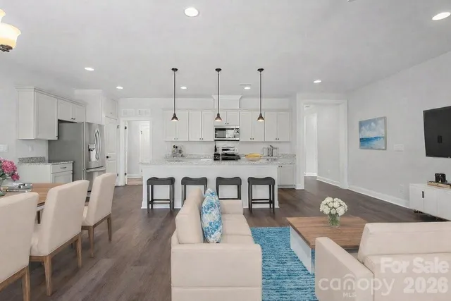 a large kitchen with a table and chairs