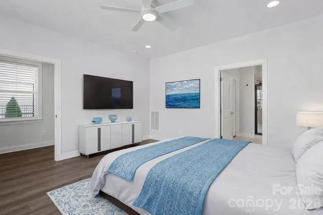 a bedroom with a bed tv and window