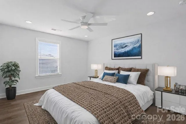 a bedroom with a large bed and a lamp