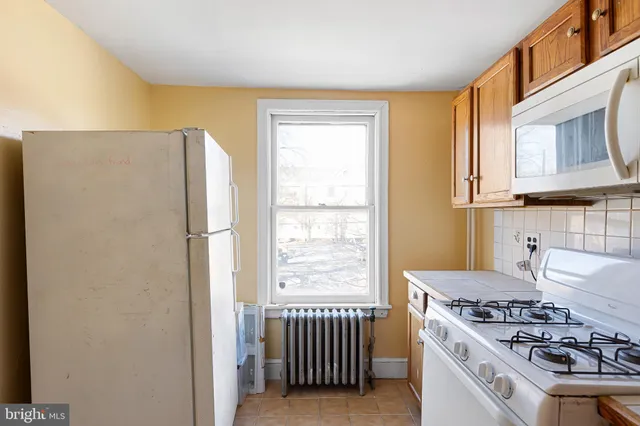 a kitchen with stainless steel appliances granite countertop a stove and a refrigerator