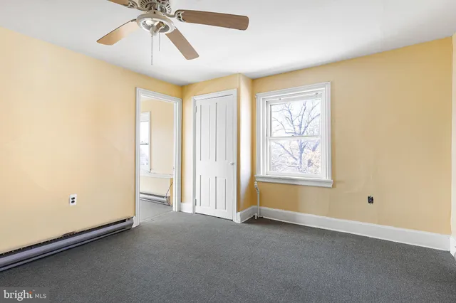 a view of room with window and ceiling fan
