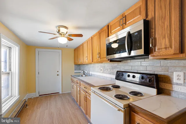 a kitchen with stainless steel appliances granite countertop a stove and a microwave