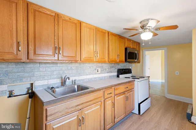 a kitchen with a sink cabinets and appliances